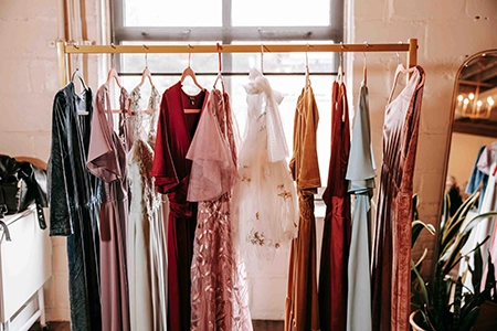 Clothing rack with wedding party gowns lined up